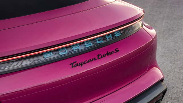 Close-up of rear badge of a plum Porsche Taycan Turbo S.