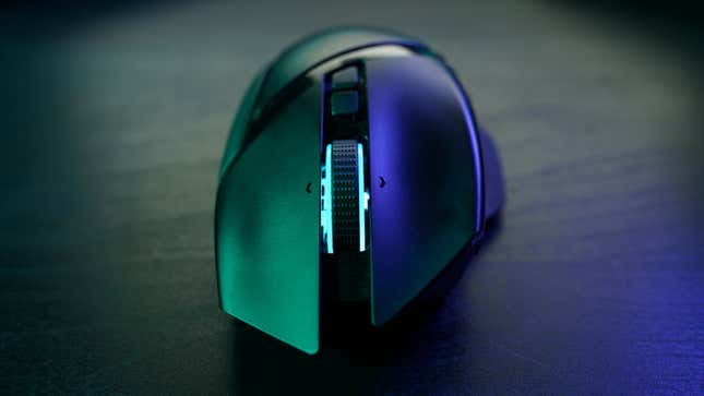 A Razer gaming mouse with a light-up scroll wheel sits on a table