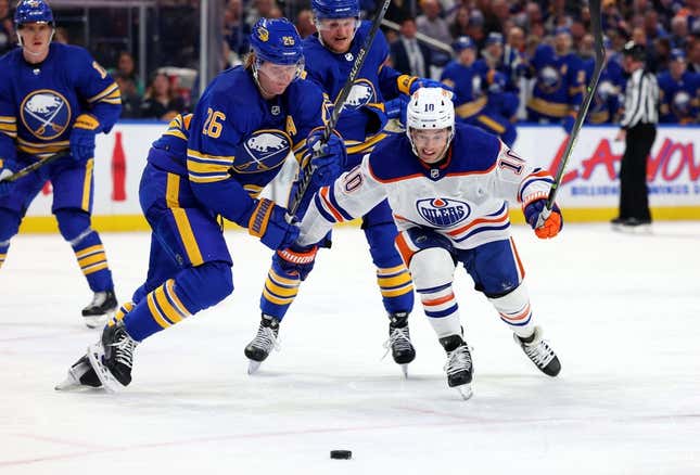 Mar 6, 2023; Buffalo, New York, USA; Buffalo Sabres defenseman Rasmus Dahlin (26) and Edmonton Oilers center Derek Ryan (10) go after a loose puck during the third period at KeyBank Center.