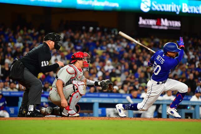 May 2, 2023; Los Angeles, California, USA; Los Angeles Dodgers right fielder Mookie Betts (50) hits a two run RBI single against the Philadelphia Phillies during the second inning at Dodger Stadium.
