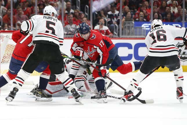 Mar 23, 2023; Washington, District of Columbia, USA; Washington Capitals center Dylan Strome (17) battles for the puck with Chicago Blackhawks left wing Jujhar Khaira (16) and Blackhawks goaltender Anton Khudobin (31) during the first period at Capital One Arena.