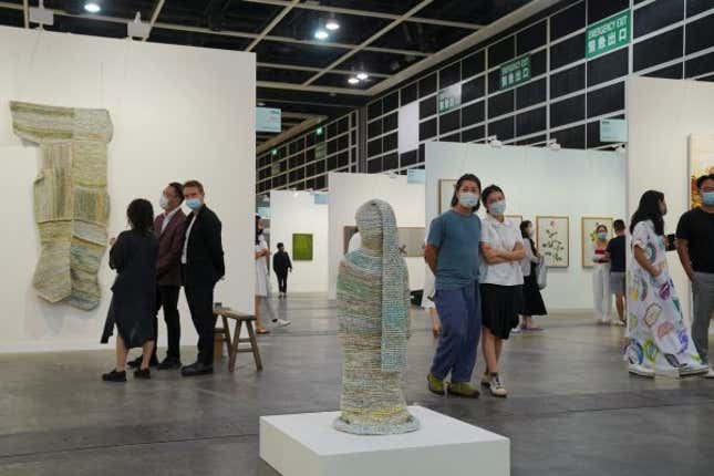 Visitors look at artworks displayed at the Art Basel in Hong Kong, China May 19, 2021.