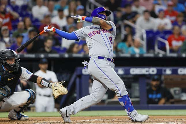 Mar 30, 2023; Miami, Florida, USA; New York Mets catcher Omar Narvaez (2) hits a single during the third inning against the Miami Marlins at loanDepot Park.