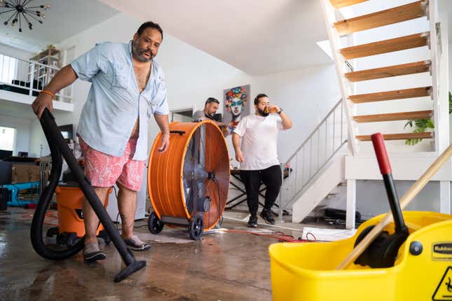 Lazaro Vento attempts to clean water out of his home in Bonita Springs, Florida, on Sunday, October 2. 