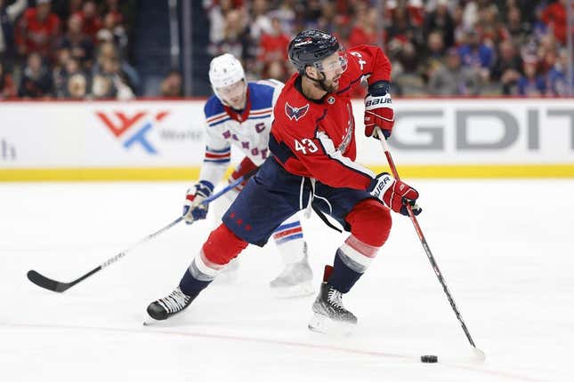 Feb 25, 2023; Washington, District of Columbia, USA; Washington Capitals right wing Tom Wilson (43) skates with the puck as New York Rangers defenseman Jacob Trouba (8) defends in the third period at Capital One Arena.