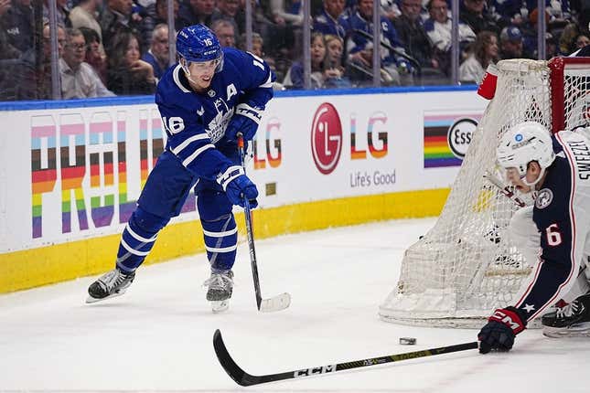 Apr 4, 2023; Toronto, Ontario, CAN; Toronto Maple Leafs forward Mitchell Marner (16) tries to pass the puck past Columbus Blue Jackets defenseman Billy Sweezey (6) during the first period at Scotiabank Arena.