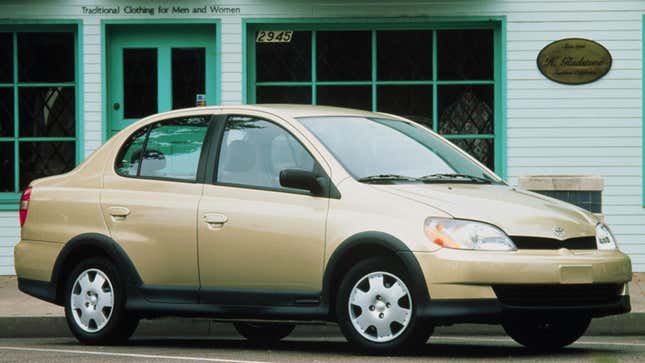 A photo of a gold Toyota Echo sedan. 