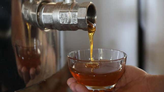 honey being poured from spigot
