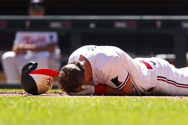 Apr 12, 2023; Minneapolis, Minnesota, USA; Minnesota Twins second baseman Kyle Farmer (12) drops to the ground after getting hit by a pitch in the face by the Chicago White Sox in the fourth inning at Target Field.