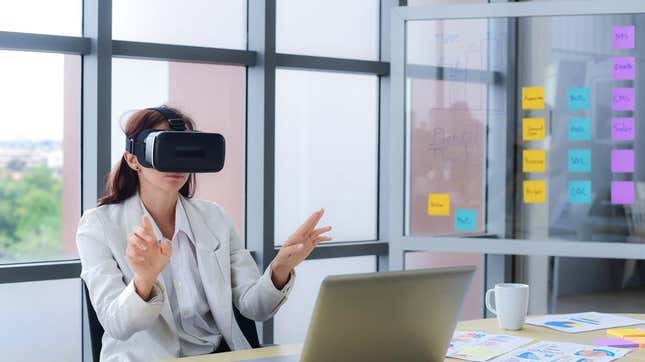 A woman using a VR headset in an office