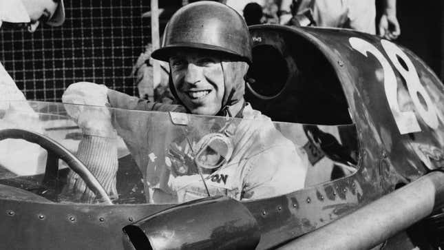 A photo of Tony Brooks in his vintage F1 race car. 