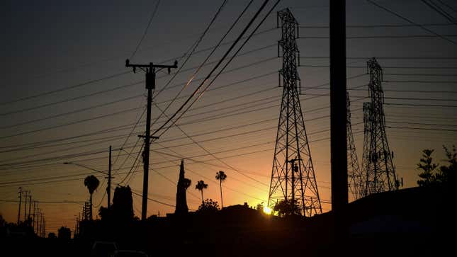 The sun sets behind power lines in Rosemead, California on June 14, 2021.