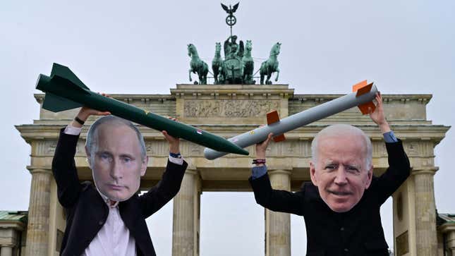 Peace activists wearing masks of Russian President Vladimir Putin (L) and newly elected US President Joe Biden pose with mock nuclear missiles in front of Berlin’s landmark the Brandenburg Gate on January 29, 2021 in an action to call for more progress in nuclear disarmament.