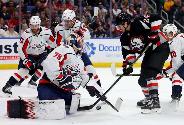 Feb 26, 2023; Buffalo, New York, USA;  Washington Capitals goaltender Charlie Lindgren (79) makes a save as Buffalo Sabres center Dylan Cozens (24) looks for a rebound during the second period at KeyBank Center.