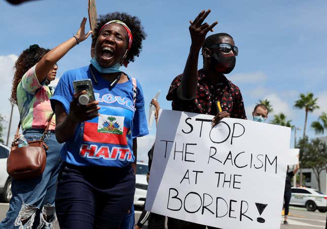 Protesters join together in front of a USCIS Building to denounce the expulsion of Haitian refugees from Del Rio, Texas, on September 22, 2021 in Miami, Florida. Thousands of mostly Haitian immigrants are in limbo on the U.S. Mexico border at Del Rio, Texas. U.S. immigration authorities have been deporting some of them directly to Haiti. 