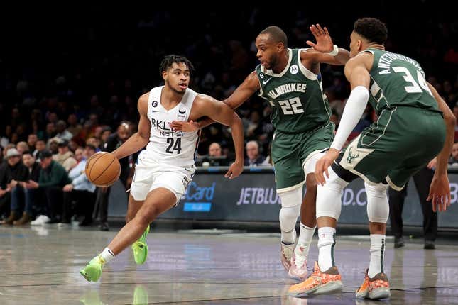 Feb 28, 2023; Brooklyn, New York, USA; Brooklyn Nets guard Cam Thomas (24) controls the ball against Milwaukee Bucks forward Khris Middleton (22) and forward Giannis Antetokounmpo (34) during the first quarter at Barclays Center.