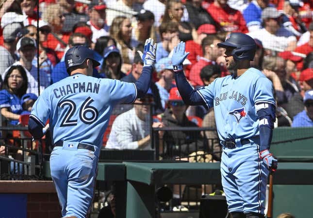 Apr 2, 2023; St. Louis, Missouri, USA;  Toronto Blue Jays third baseman Matt Chapman (26) is congratulated by right fielder George Springer (4) after scoring against the St. Louis Cardinals during the second inning at Busch Stadium.
