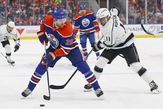 Mar 30, 2023; Edmonton, Alberta, CAN; Edmonton Oilers forward Leon Draisaitl (29) protects the puck from Los Angeles Kings forward Anze Kopitar (11) during the first period at Rogers Place.