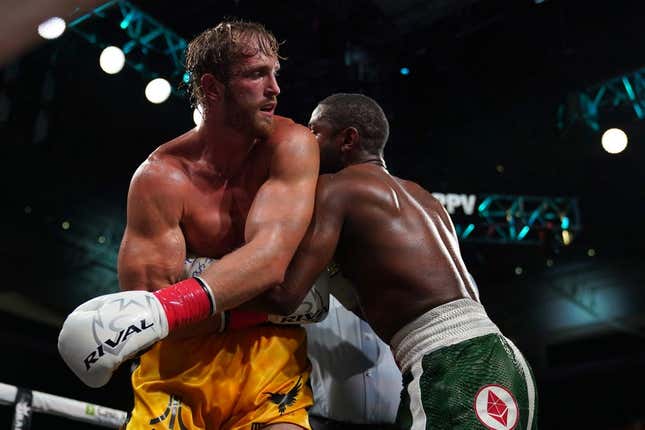 Jun 6, 2021; Miami, Florida, USA; Floyd Mayweather Jr. (Green Trunks) fights Logan Paul (Yellow Trunks) during an exhibition boxing match at Hard Rock Stadium.