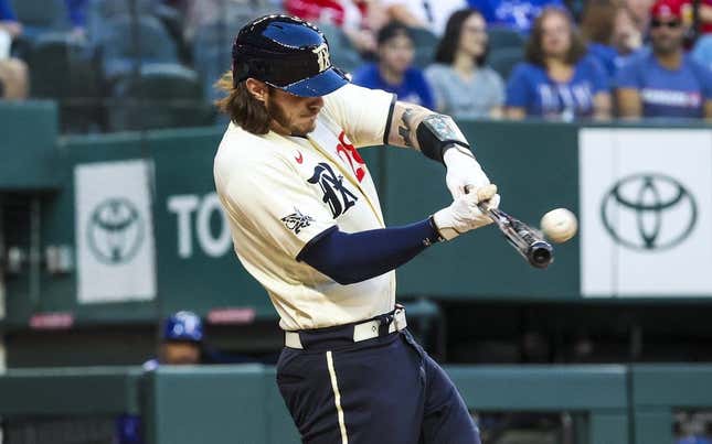 Apr 21, 2023; Arlington, Texas, USA;  Texas Rangers catcher Jonah Heim (28) hits a three-run home run during the first inning against the Oakland Athletics  at Globe Life Field.