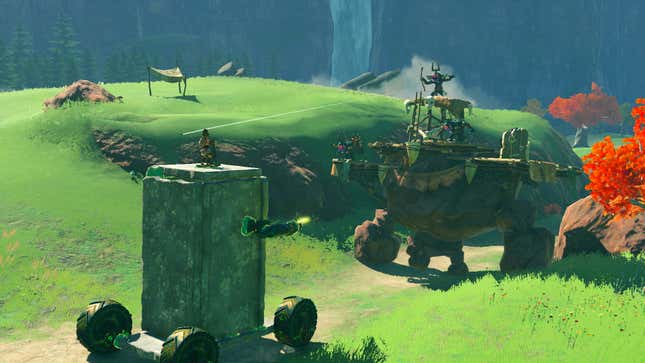 Link in Tears of the Kingdom is sitting atop of a giant war vehicle, shooting guns at what appears to be an enemy camp.