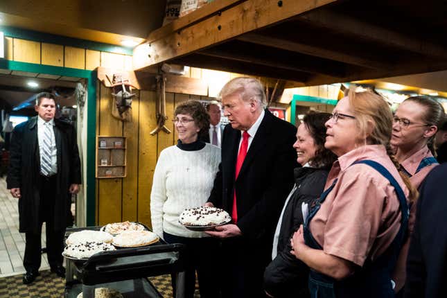 Former President Donald Trump holds a pie as he greets patrons at the Machine Shed Restaurant on Monday, March 13, 2023, in Davenport, Iowa.