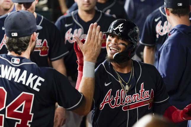 May 17, 2023; Arlington, Texas, USA; Atlanta Braves shortstop Orlando Arcia (11) is greeted in the dugout after hitting a go ahead solo home run against the Texas Rangers during the ninth inning at Globe Life Field.