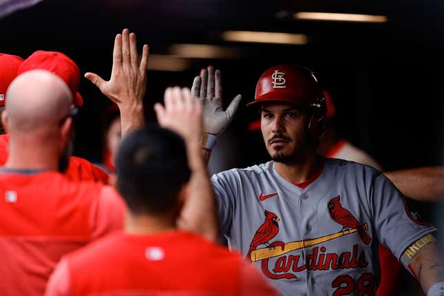 Apr 12, 2023; Denver, Colorado, USA; St. Louis Cardinals designated hitter Nolan Arenado (28) celebrates in the dugout on a two run home run in the fourth inning against the Colorado Rockies at Coors Field.