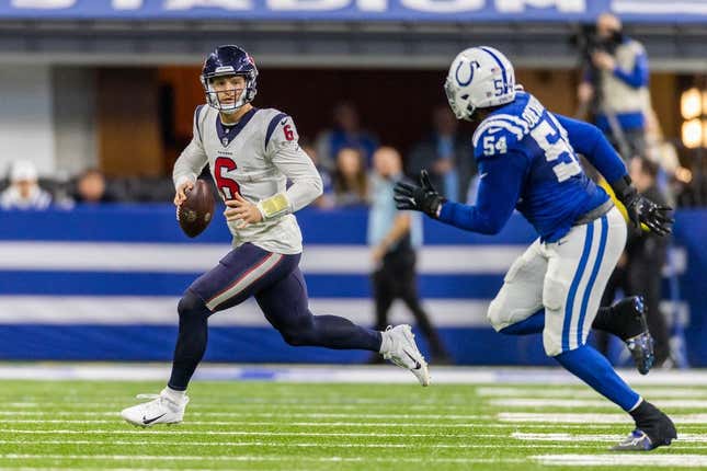Jan 8, 2023; Indianapolis, Indiana, USA; Houston Texans quarterback Jeff Driskel (6) runs to pass the ball while Indianapolis Colts defensive end Dayo Odeyingbo (54) defends in the first half at Lucas Oil Stadium.