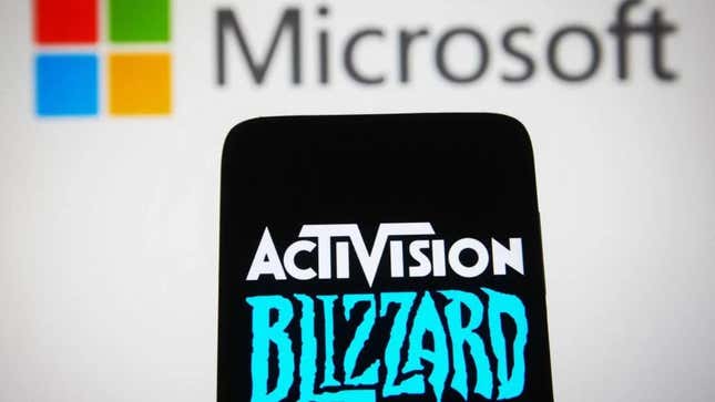 A photo shows the Activision Blizzard logo on a phone in front of the Microsoft logo.