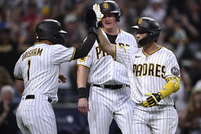 Aug 21, 2023; San Diego, California, USA; San Diego Padres second baseman Ha-seong Kim (7) is congratulated by center fielder Trent Grisham (1) after hitting a grand slam home run against the Miami Marlins during the second inning at Petco Park.