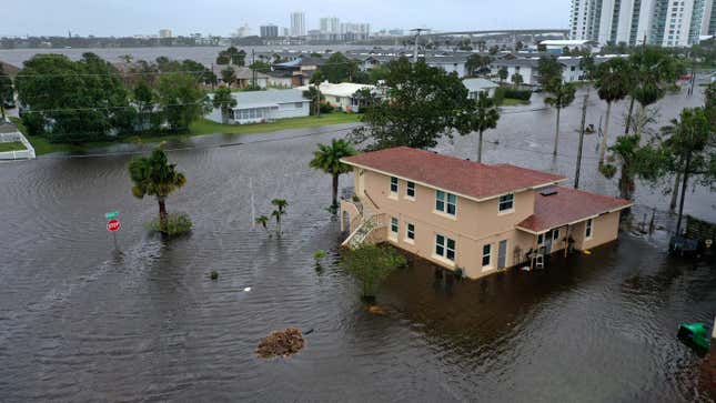 Flood water surrounds a house after Hurricane Nicole.
