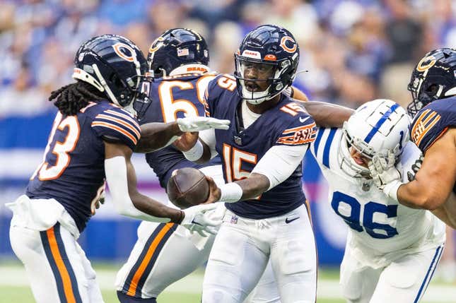 Aug 19, 2023; Indianapolis, Indiana, USA; Chicago Bears quarterback PJ Walker (15) hands off the ball to  wide receiver Nsimba Webster (83) in the first quarter against the Indianapolis Colts at Lucas Oil Stadium.