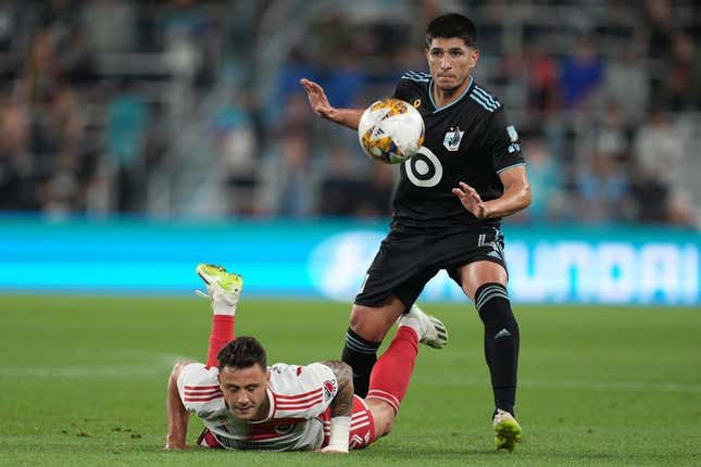 Sep 9, 2023; Saint Paul, Minnesota, USA;  New England Revolution forward Giacomo Vrioni (9) and Minnesota United defender Miguel Tapias (4) battle for the ball during the first half at Allianz Field.