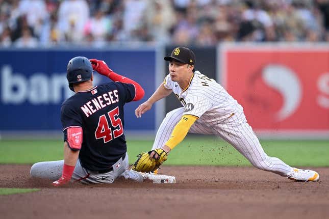 Jun 24, 2023; San Diego, California, USA; San Diego Padres second baseman Ha-seong Kim (right) tags out Washington Nationals designated hitter Joey Meneses (45) at second base during the sixth inning at Petco Park.