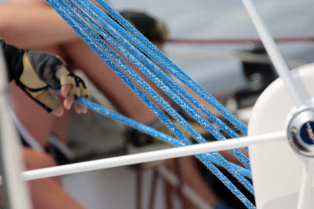 Kyra as main trimmer for Team Q, the sailing team she manages.