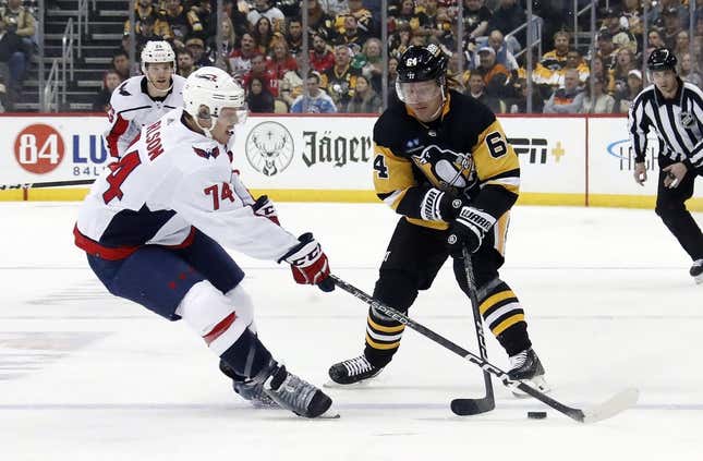 Mar 25, 2023; Pittsburgh, Pennsylvania, USA;  Washington Capitals defenseman John Carlson (74) defends Pittsburgh Penguins center Mikael Granlund (64) during the first period at PPG Paints Arena.