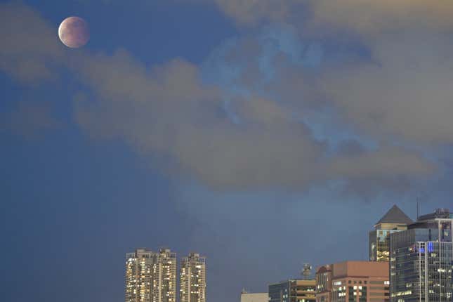 The moon is pictured above Hong Kong on May 26, 2021, during a total lunar eclipse as stargazers across the Pacific are casting their eyes skyward to witness a rare "Super Blood Moon". 