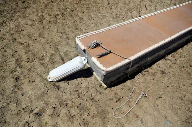 An empty boat dock sits on dry land at the Browns Ravine Cove area of drought-stricken Folsom Lake, in Folsom, California on May 22, 2021. 