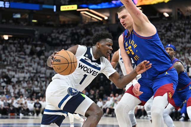Apr 21, 2023; Minneapolis, Minnesota, USA; Minnesota Timberwolves guard Anthony Edwards (1) goes to the basket as Denver Nuggets center Nikola Jokic (15) defends during the fourth quarter of game three of the 2023 NBA Playoffs at Target Center.