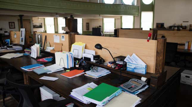 Papers and folders on top of office desk.