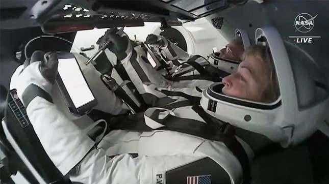 Ax-2 Commander Peggy Whitson and Pilot John Shoffner inside the SpaceX Dragon Freedom spacecraft preparing to undock from the ISS.