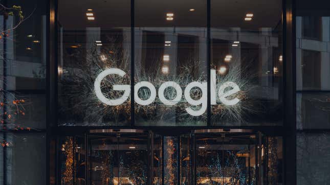 An image of the Google logo surrounded by white decorative vines in an office building.