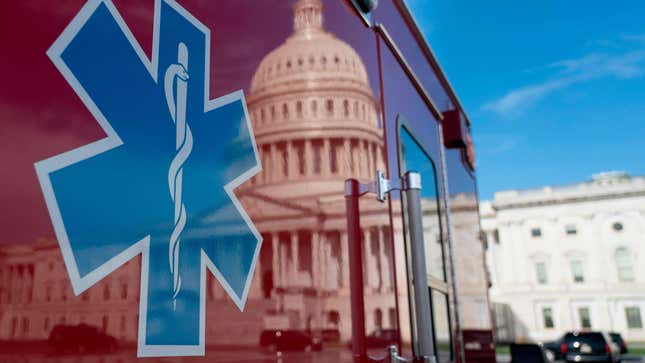The US Capitol is reflected in a standby ambulance on March 27, 2020, in Washington, DC. 