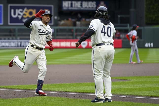 Apr 23, 2023; Minneapolis, Minnesota, USA; Minnesota Twins infielder Jorge Polanco (11) celebrates his solo home run against the Washington Nationals with third base coach Tommy Watkins (40) during the fourth inning at Target Field.