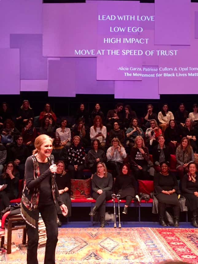 Gloria Steinem leading the theatre audience in a talking circle.