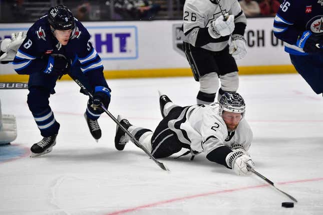 Mar 25, 2023; Los Angeles, California, USA; Los Angeles Kings defenseman Alexander Edler (2) plays for the puck against Winnipeg Jets right wing Saku Maenalanen (8) during the third period at Crypto.com Arena.