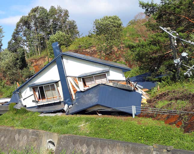 A collapsed house is seen following a large landslide that occured after an earthquake hit Atsuma in Hokkaido.