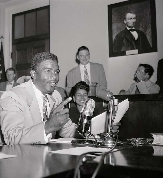 Jackie Robinson, ace second baseman for the Brooklyn Dodgers, told the House Unamerican Activities Committee today that singer Paul Robeson was “silly” when he declared that American Blacks would not fight against Russia. The testimony of Robinson, whose wife, Rachel, is seated in the background, was arranged by Black spokesmen to repudiate Robinson’s statement.