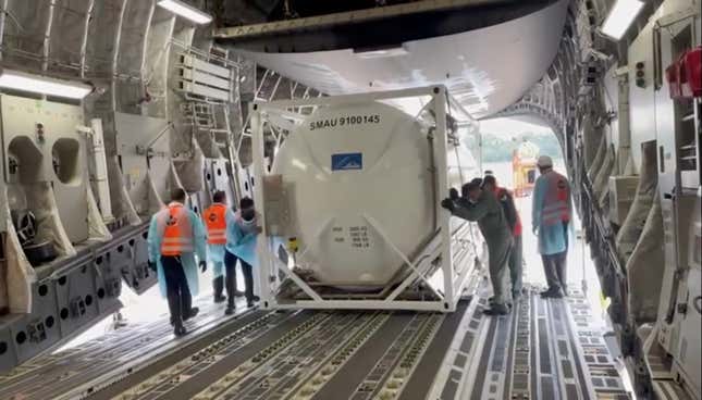 Oxygen tank is loaded into aircraft to supply hospitals in India, at Changi Airport in Singapore